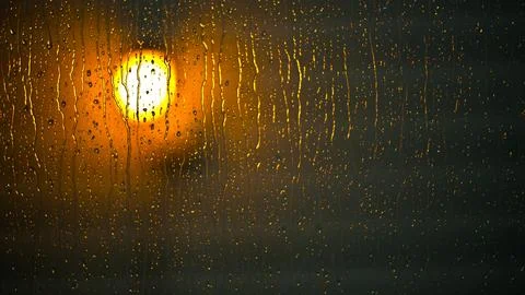 4K Close-Up of Raindrops on Window, with Defocused Street Lights Outside Stock Photos