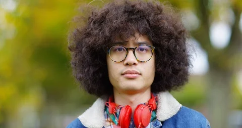 4K Close up serious young man outdoors in nature, staring intently at camera Stock Footage 87146899