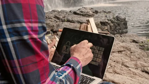 4k close up shot of camping man and trekker using banking app on touchscreen com Stock Footage 199620545