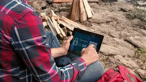4k close up shot of camping man and trekker using banking app on touchscreen at Stock Footage 199621163