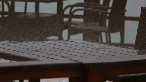 4K Close up shot how rain drops fall on the wooden table Stock-Footage 99934383
