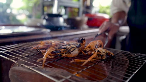4K, Close-up shot of a large river prawn being grilled over a hot coal stove. Stock Footage 202971986
