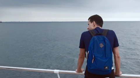 4K Close up shot of a man from back standing onboard and watching the sea Vidéo 99932193