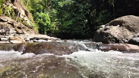 4K Close Up Shot Pushing Toward Water Flowing Over Rocks In Rainforest River Stock Footage 285871775