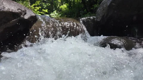 4K Close Up Shot Pushing Toward Water Flowing Over Waterfall In Rainforest River Stock Footage 285871851