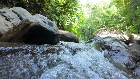 4K Close Up Shot Pushing Toward Water Flowing Over Waterfall In Rainforest River Stock Footage 285872068