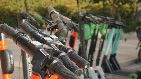 4k close up shot selective focus of handle bars of electric shared scooters Stock Footage 123412924