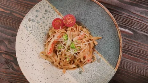 4K Close Up Shrimp Pasta Dish Creamy Sauce Tomatoes Shredded Cheese Stock Footage 328536305
