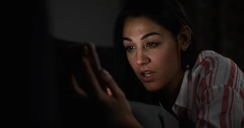 4K Close up of smiling girl using her phone to send a message on dating app Video stock 108518641