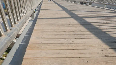 4k close up static shot of feet walking or riding an electric scooter on bridge. Stock Footage 122817168