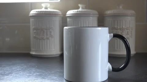 4k close up of steaming cup of coffee/tea with hot water pouring in Video stock 47371993
