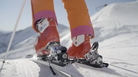 4K close up strap on your skies and go skiing Stock Footage 100109552