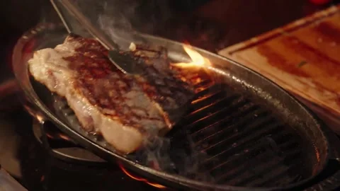 4K Close-up Thick T-Bone Steak Grilling Hot Pan Sizzle and Smoke Stock-Footage 330480982