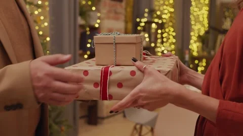 4K Close Up Two People Exchanging Christmas Gifts Holiday Tradition Stock-Footage 334442956