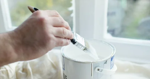 4K Close up of unrecognizable man painting indoor window frames with white paint Stock Footage 88220894
