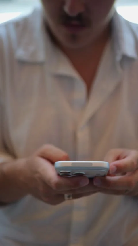4K Close-Up Vertical Shot Of Person Using Smartphone Indoors... 動画素材 334437428