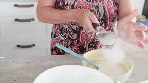 4K close-up video of dought being whisked in deep white bowl while making apple Stock-Footage 319968434