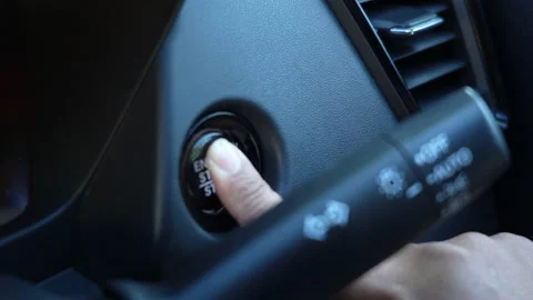 4K close up video of a hand pressing the start engine button to start a modern c Stock-Footage 315380731