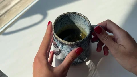 4K close-up video of a woman's hand picking up a large cup Stock Footage 342071614
