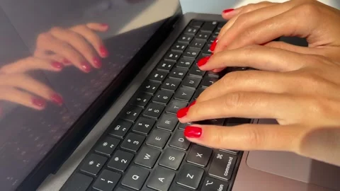 4K close-up video of a woman's hands actively typing on a computer keyboard Stock Footage 342065256