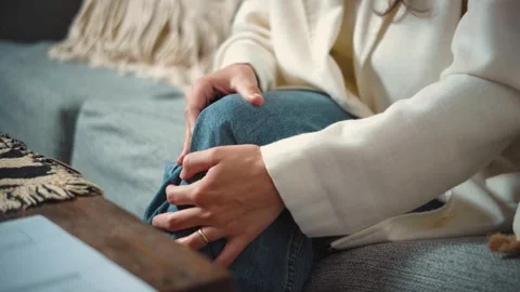 4K close-up video of a young woman's hands massaging her painful knee. Physical  Stock Footage 346713765