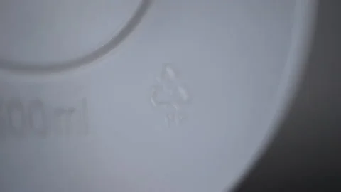 4k Close view of 05 pp recycling signs and others on white product or garbage Stock Footage 198812713
