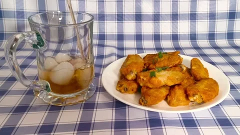 4k Close up view. Pouring cola drink into glass cup with ice cubes served w.. Stockbeeldmateriaal 318252735