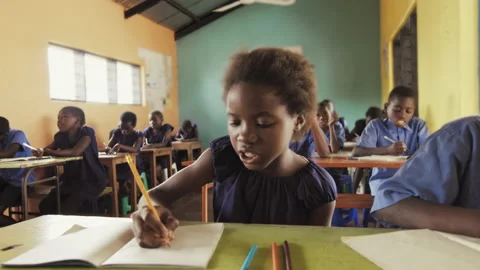 4k close view of pupils in classroom of African children writing English in scho Stock Footage 199625174