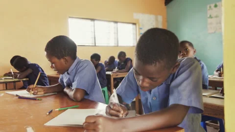 4k close view of pupils in classroom of African children writing English in scho Vídeos de archivo 199625234