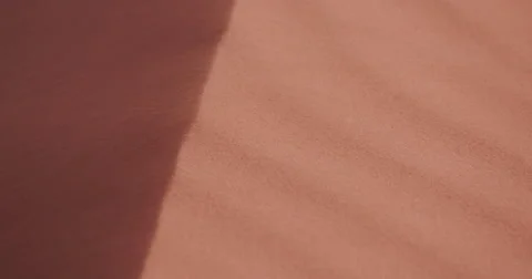 4K close-up view of sand blowing off the edge of a dune Stock Footage 64697113