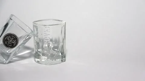 4K Close-up view of two vintage shot glasses leaning on each other Stock Footage 281595482