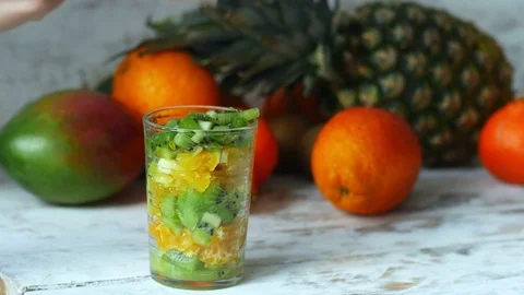 4k close up of woman hands adding yogurt in fruit salad Video stock 77061124