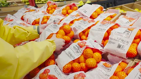 4K Close-Up of a Woman's Hand Selecting Mandarin Oranges at Superstore Video stock 236830078