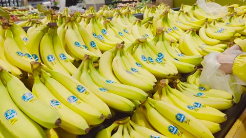 4K Close-Up of a Woman's Hand Selecting Banana at Superstore Video stock 236830283