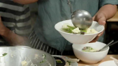 4k, Close Up A woman's hand is using a dipper to scoop sukiyaki in a red pot, Stock Footage 168476082