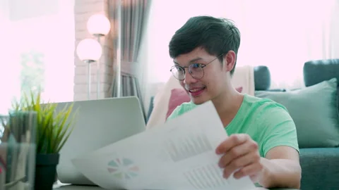 4K, Close-up of a young Asian man wearing a green shirt, explaining his work Stock Footage 197367257