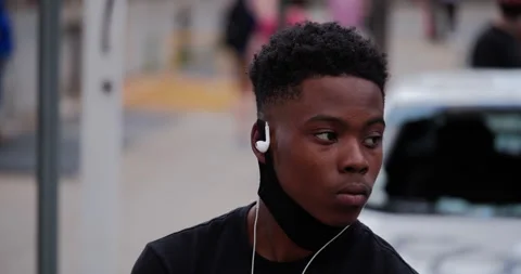 4K CLOSE UP OF YOUNG BOY WITH FACE MASK OBSERVING PROTEST Stock Footage 131459193