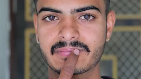 4K Close-up of a Young Man Applying Lip Balm or Ointment to Chapped Lips Stock Footage 330572790