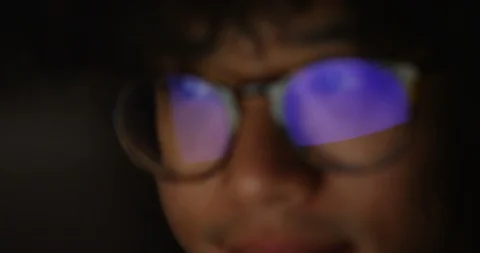 4K Closeup eyes of man working on computer with screen reflected in his glasses Stock Footage 87117995