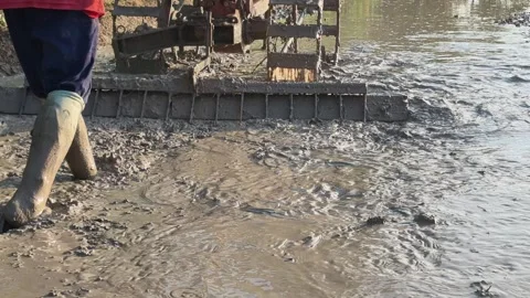 4k of closeup farmer using tiller tractor to plow paddy field 스톡 동영상 336037179
