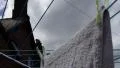 4K Closeup of hands hanging up laundry on a washing line outside with house 4k or 4k+ Resolution