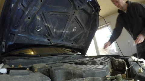 4k closeup man checks engine oil Stock Footage 61416699