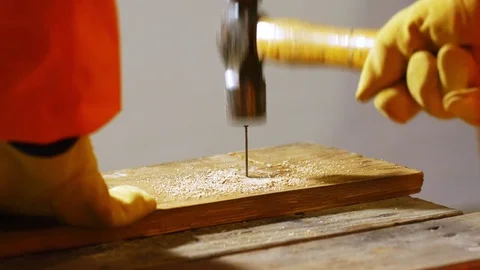 4k closeup of a man hammering a nail into old wooden board. Video stock 73136400