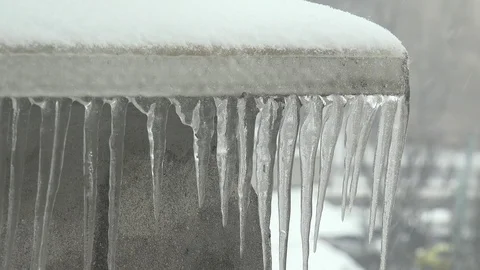 4K Closeup many icicles hang on rooftop in cold winter season day frozen water Stock Footage 108476350