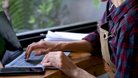 4k, closeup multitask coffee shop owner typing and checking stack of the in.. Stock Footage 247006063
