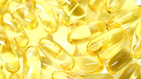 4K closeup Omega 3 fish oil pills background, vitamin E natural capsules texture Stock Footage 149285253