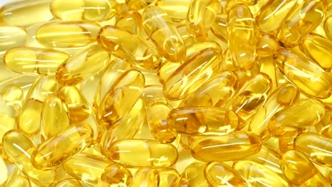 4K closeup Omega 3 fish oil pills background, vitamin E natural capsules texture Stock Footage 150009813