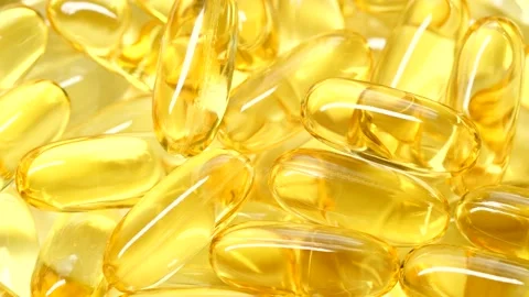 4K closeup Omega 3 fish oil pills background, vitamin E natural capsules texture Vídeos de archivo 151062818