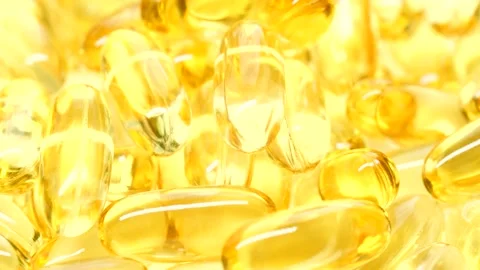 4K closeup Omega 3 fish oil pills background, vitamin E natural capsules texture Stock Footage 151499484