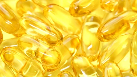 4K closeup Omega 3 fish oil pills background, vitamin E natural capsules texture Vídeo Stock 151811852